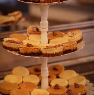 Three tiers of cheesecakes on a table